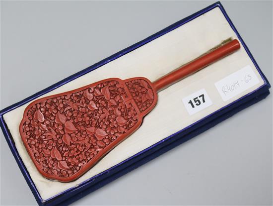 An Oriental carved hand mirror